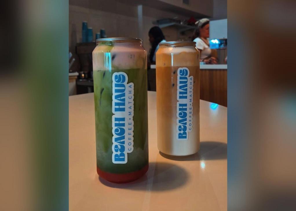 A Beach Haus canned iced matcha latte and iced latte side by side on a counter